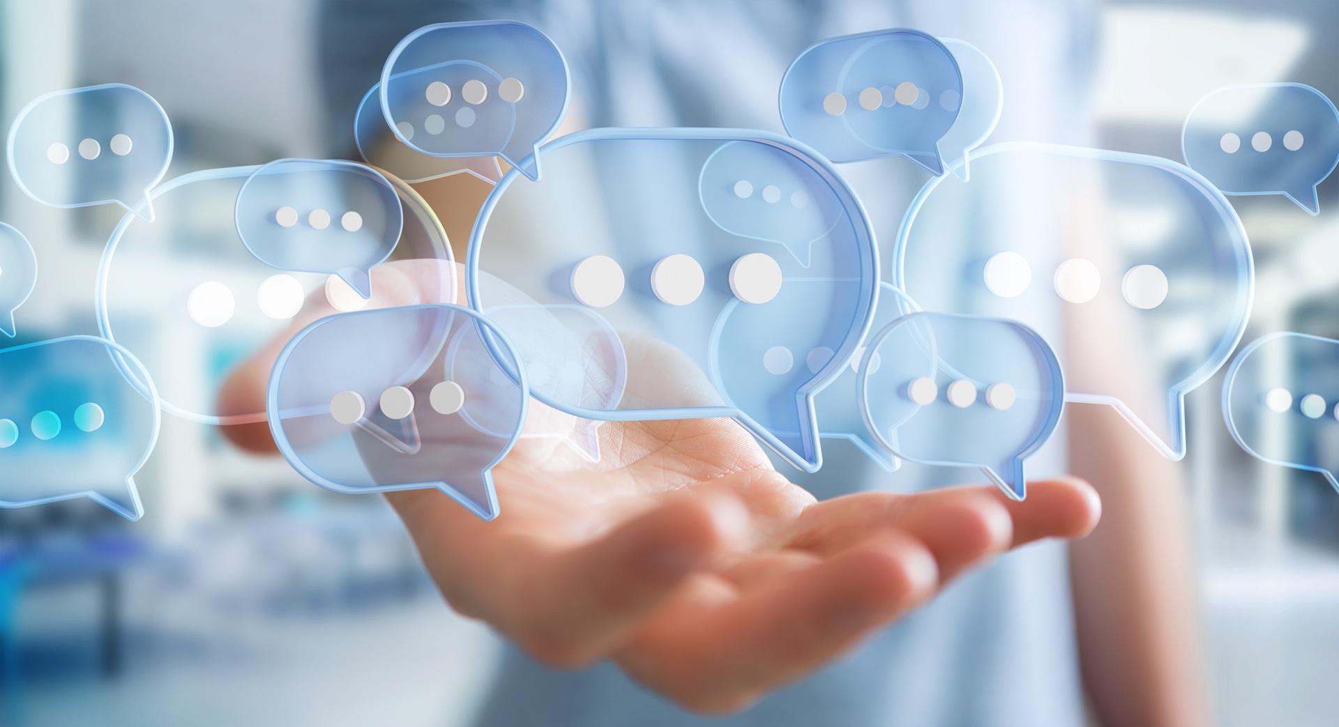 Hand mit digitalen Chatsymbolen | Verhandlungstraining